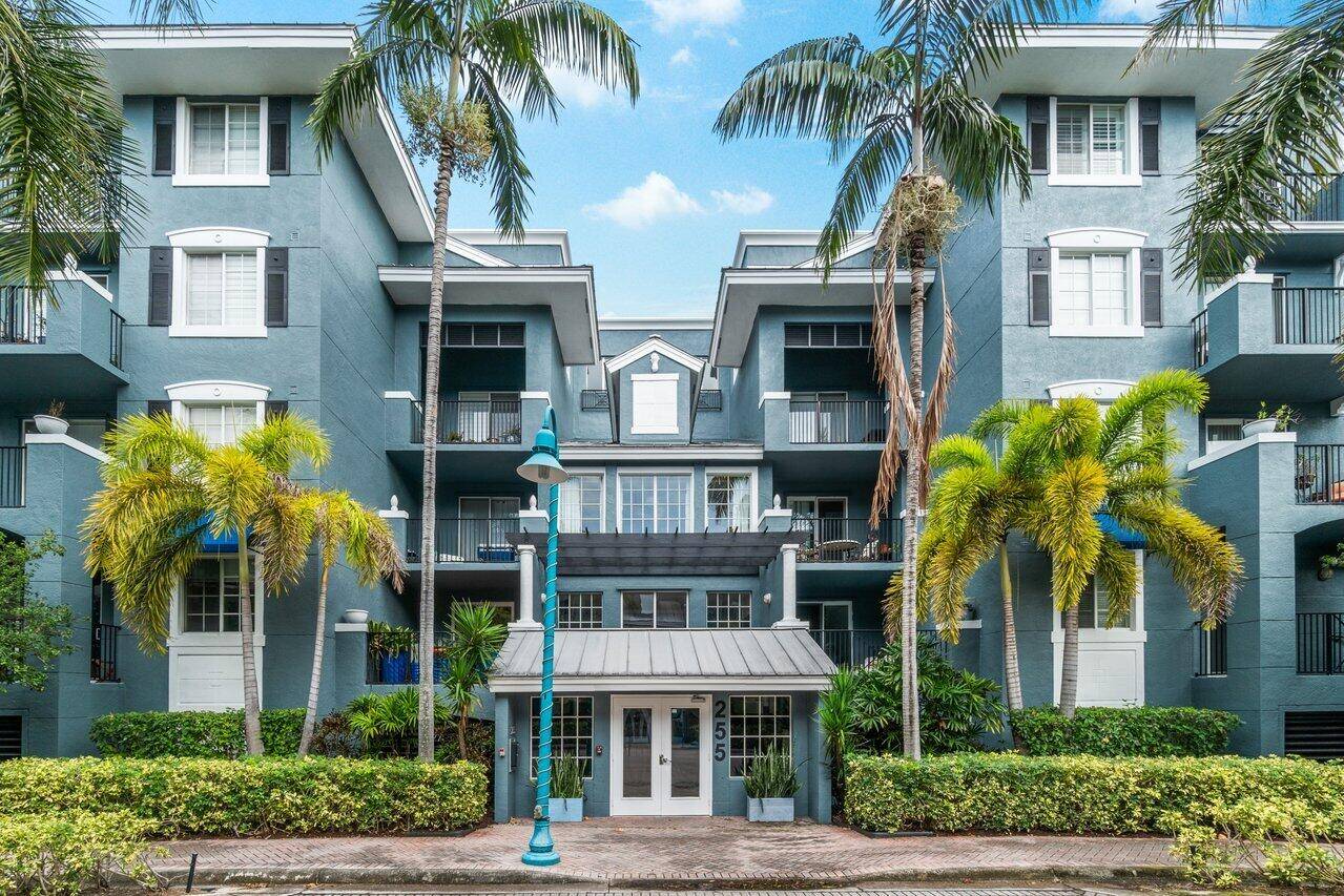 Call the heart of Pineapple Grove home w this spacious 1 1 corner ''interior'' condo !