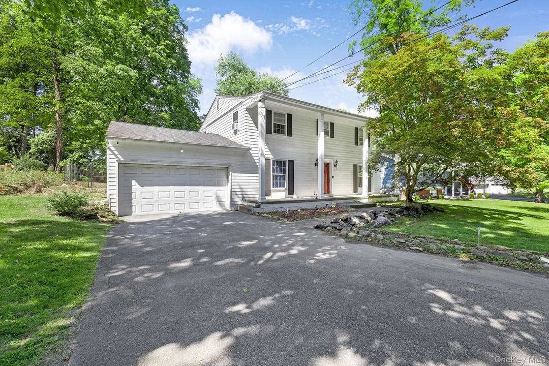 Set in a beautiful neighborhood of mature trees and well kept homes, this four bedroom, three bath Colonial combines classic charm with modern comfort.