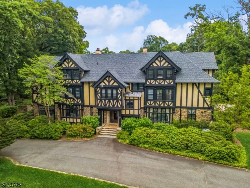 Impressive Tudor manor home is nestled on 3.