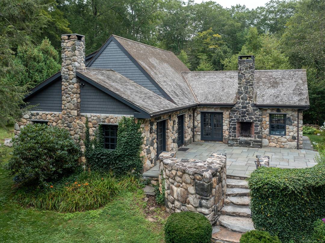 A Storybook Stone Cottage with 2000 feet of frontage along the Shepaug River.