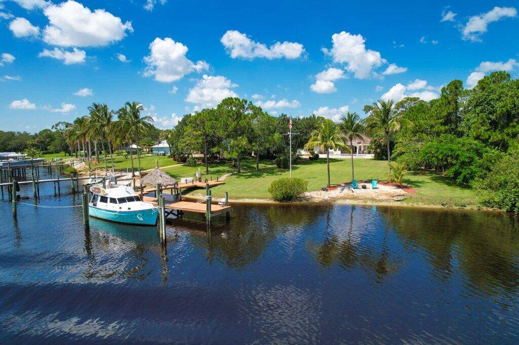 Exquisite Waterfront Estate with Guest Home Resort Style Amenities in Gated Community.