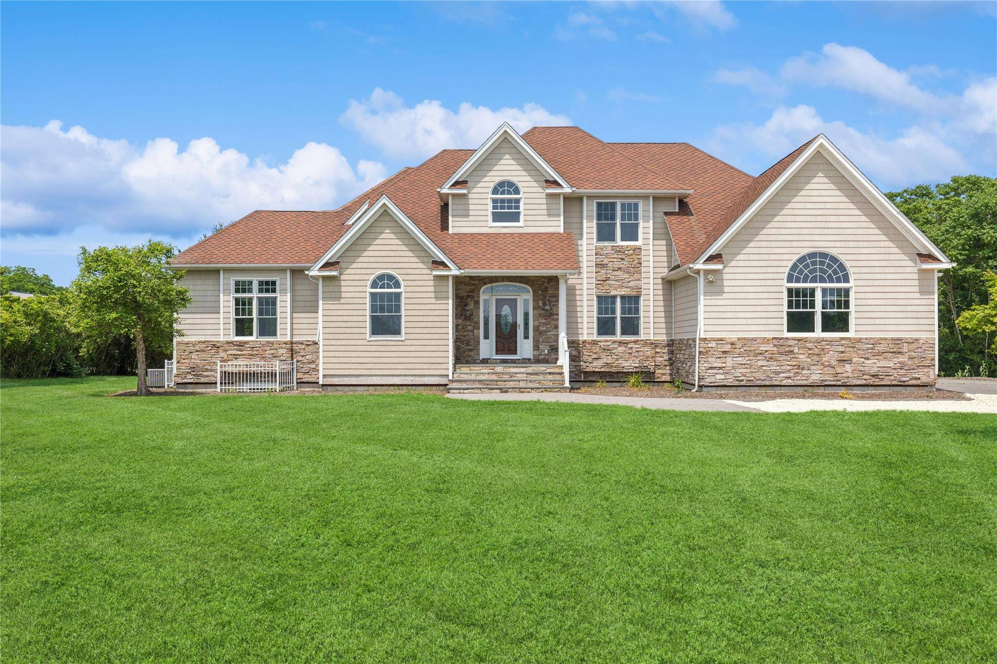 Nestled in the heart of Southold s coveted North Fork, 1465 Ackerly Pond Lane offers a rare opportunity to own a custom home on over 2.