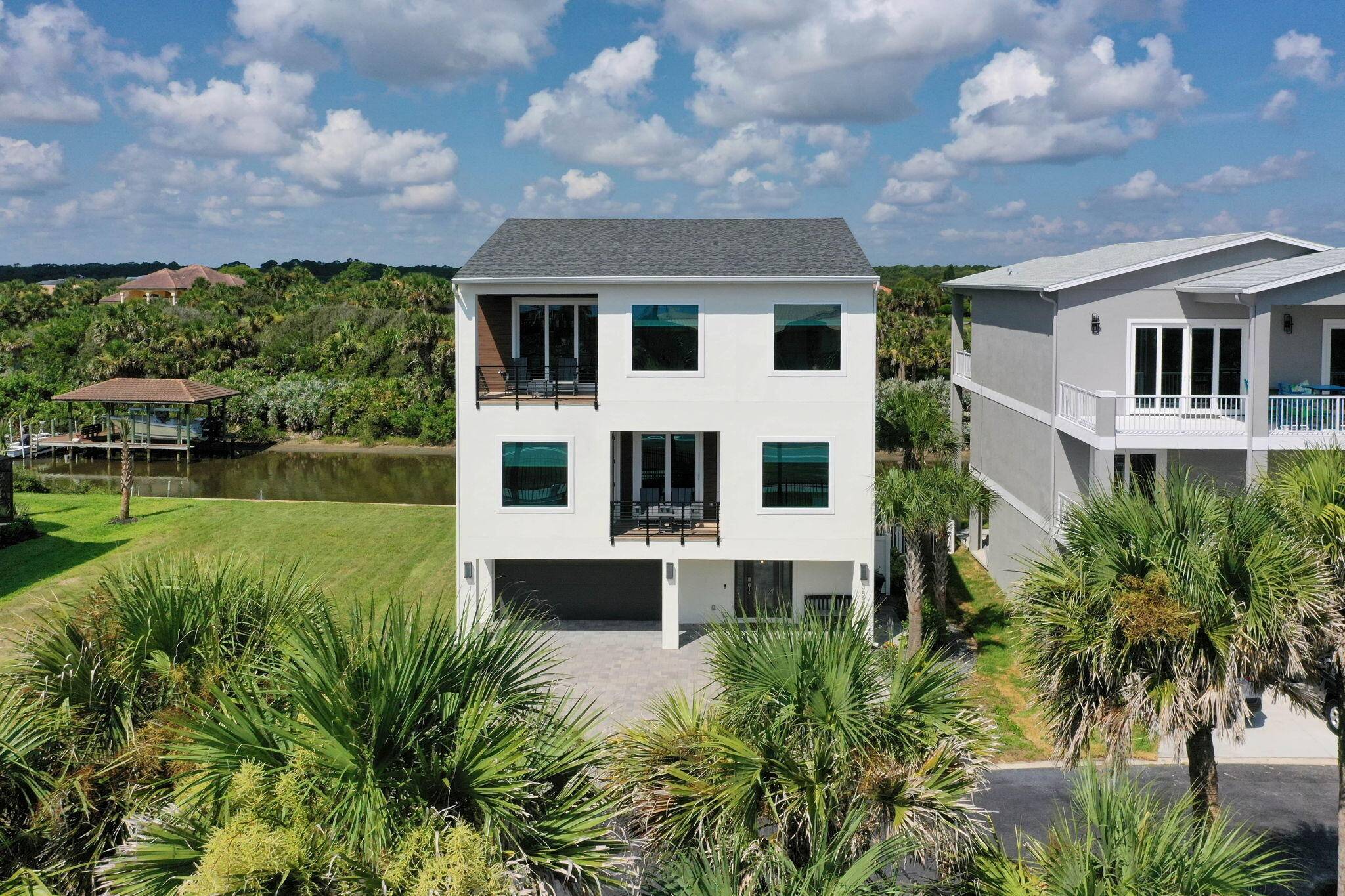 Experience the ultimate Florida coastal lifestyle in this stunning fully furnished three story home with deeded beach access and quick Intracoastal Waterway access.