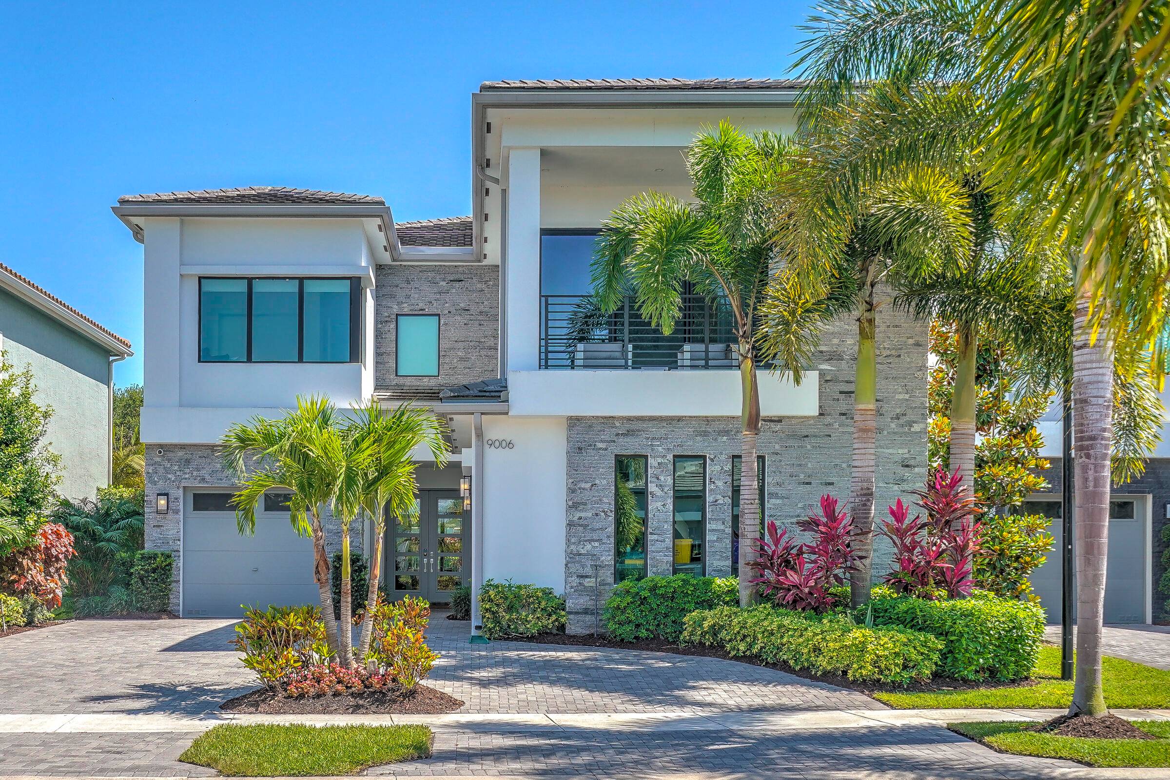 Exquisite contemporary Anabelle model offering 5 bedrooms, 6 bathrooms, loft, club room, and 3 car garage in coveted Boca Bridges.