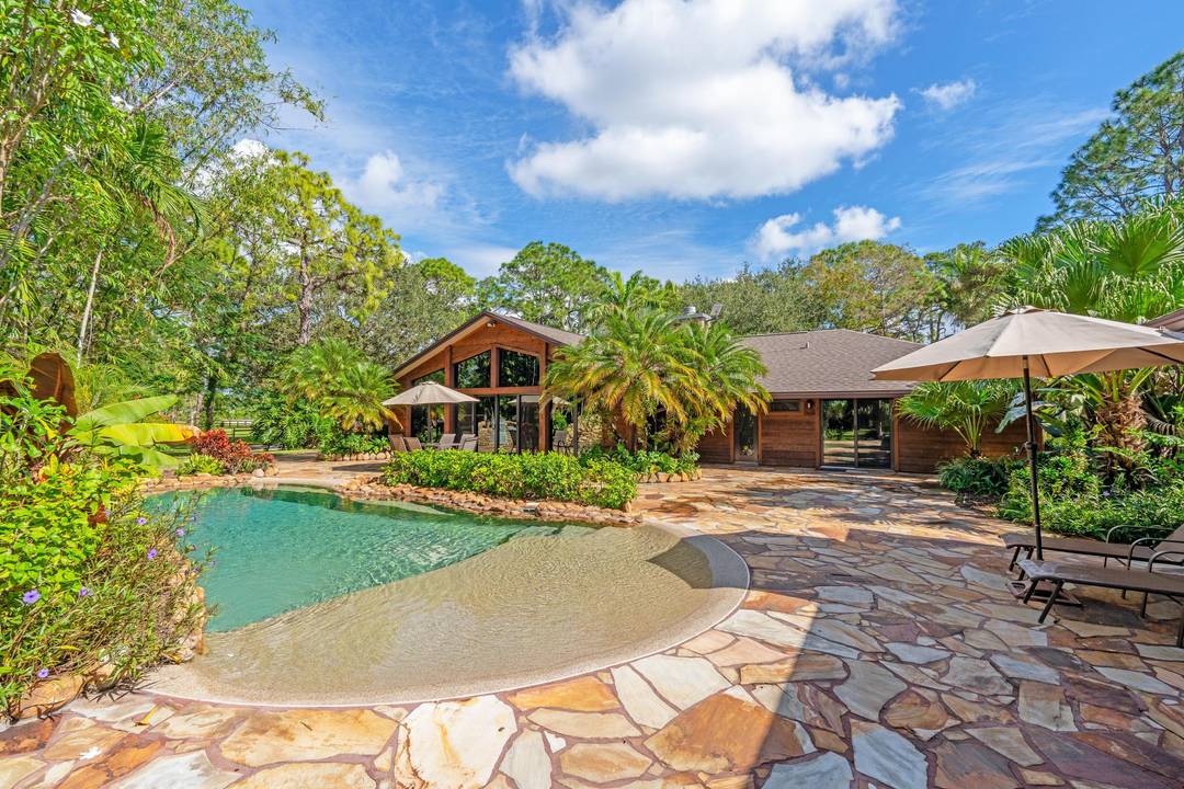 Welcome Home Welcome home to this rustic estate retreat set on 5 private acres within the securely gated community of Homeland in Wellington.