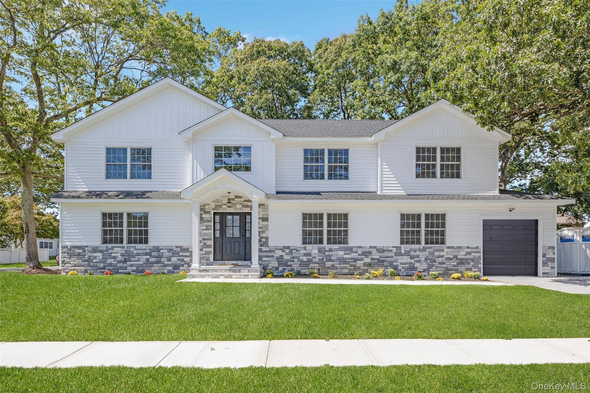 Nestled on an oversized 100x105 lot in the highly sought after Village of Massapequa Park, this beautiful 5 bedroom, 3 bath home blends timeless craftsmanship with modern comforts.