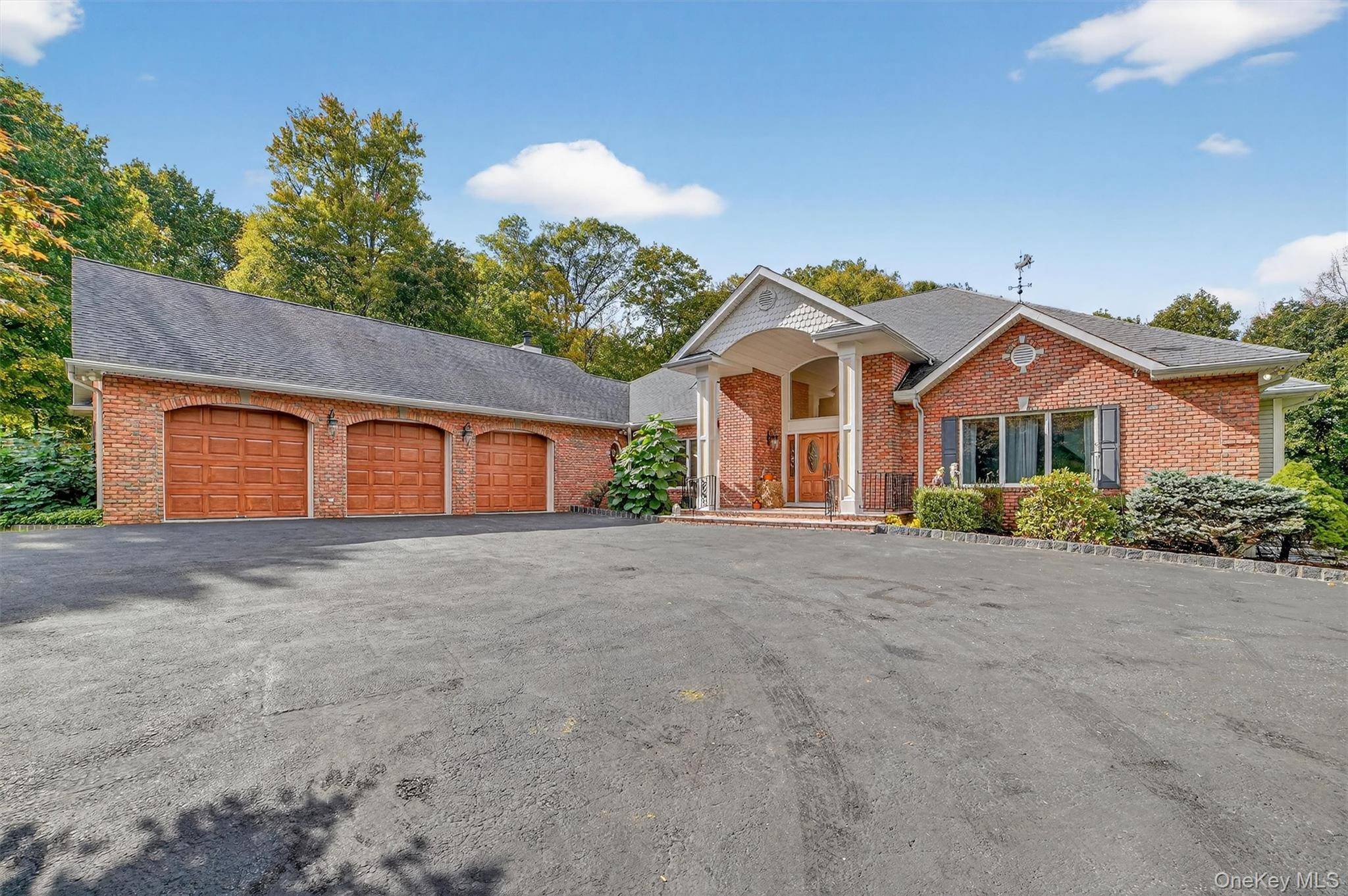 A long driveway leads to this custom built sprawling ranch set on a secluded 16 acre parcel with unmatched privacy.