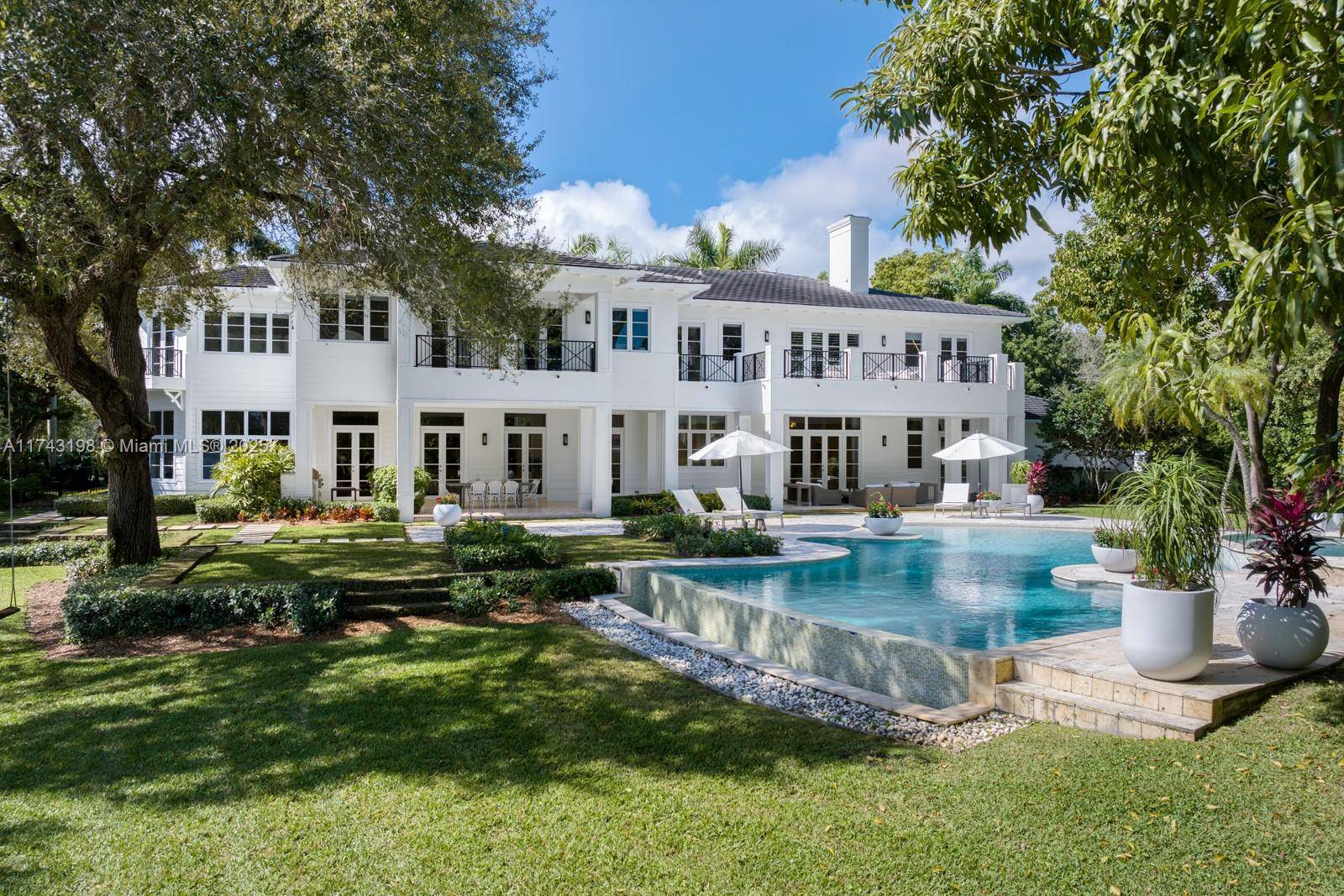 Experience the pinnacle of lakefront luxury on Hammock Lake in Coral Gables.