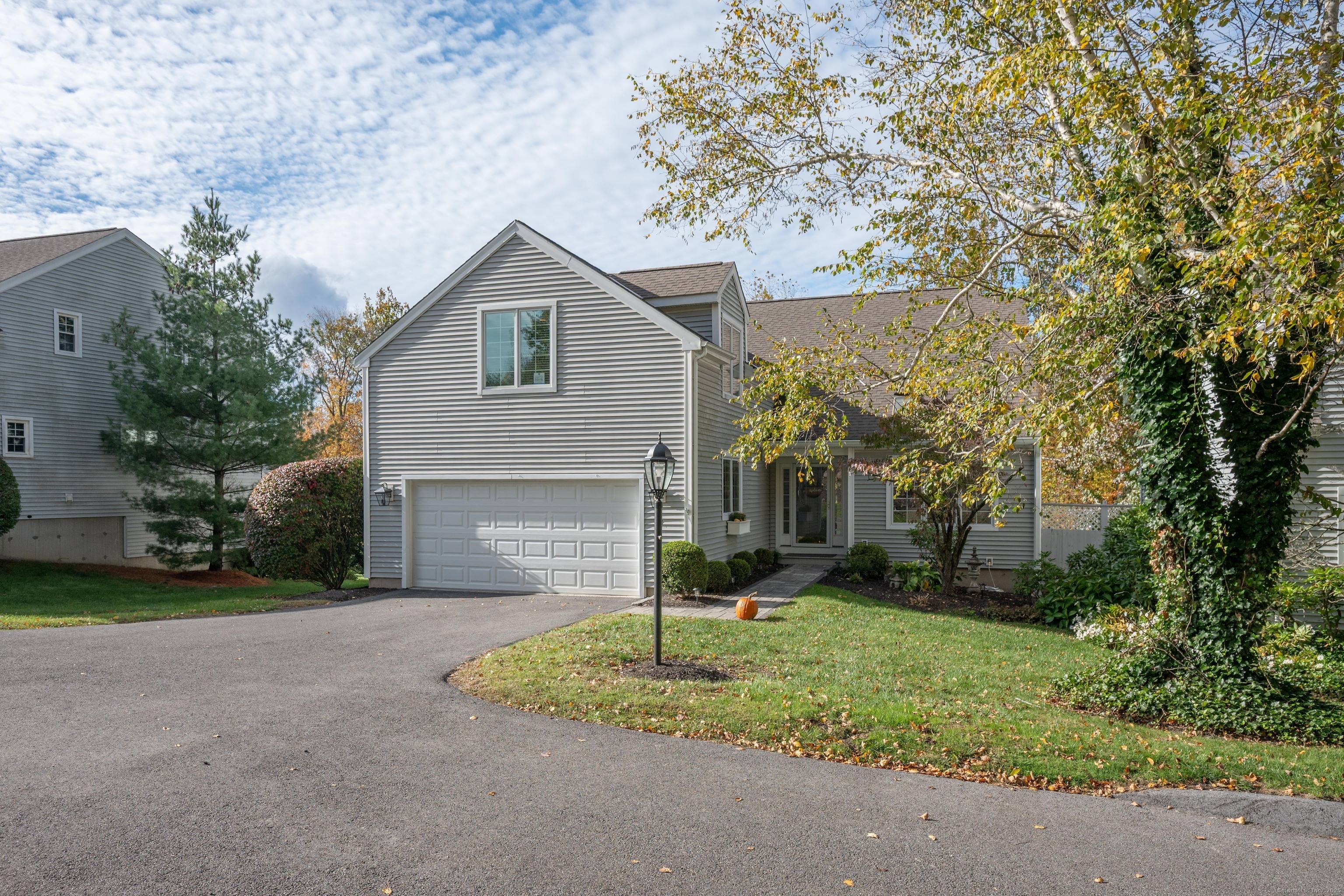 Beautiful free standing carriage home in High Meadow featuring almost 3000 sf of living space with a main level primary suite.