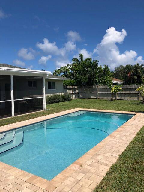 Enjoy easterly breezes in the peaceful private fenced yard with pool and covered lanai.