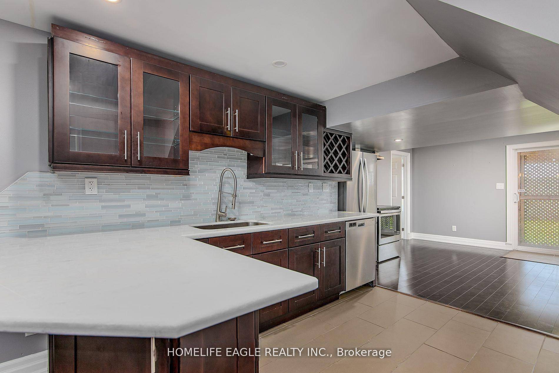This legal walk out unit feels more like a main floor apartment, its above ground location filled with natural light, and features large windows throughout.