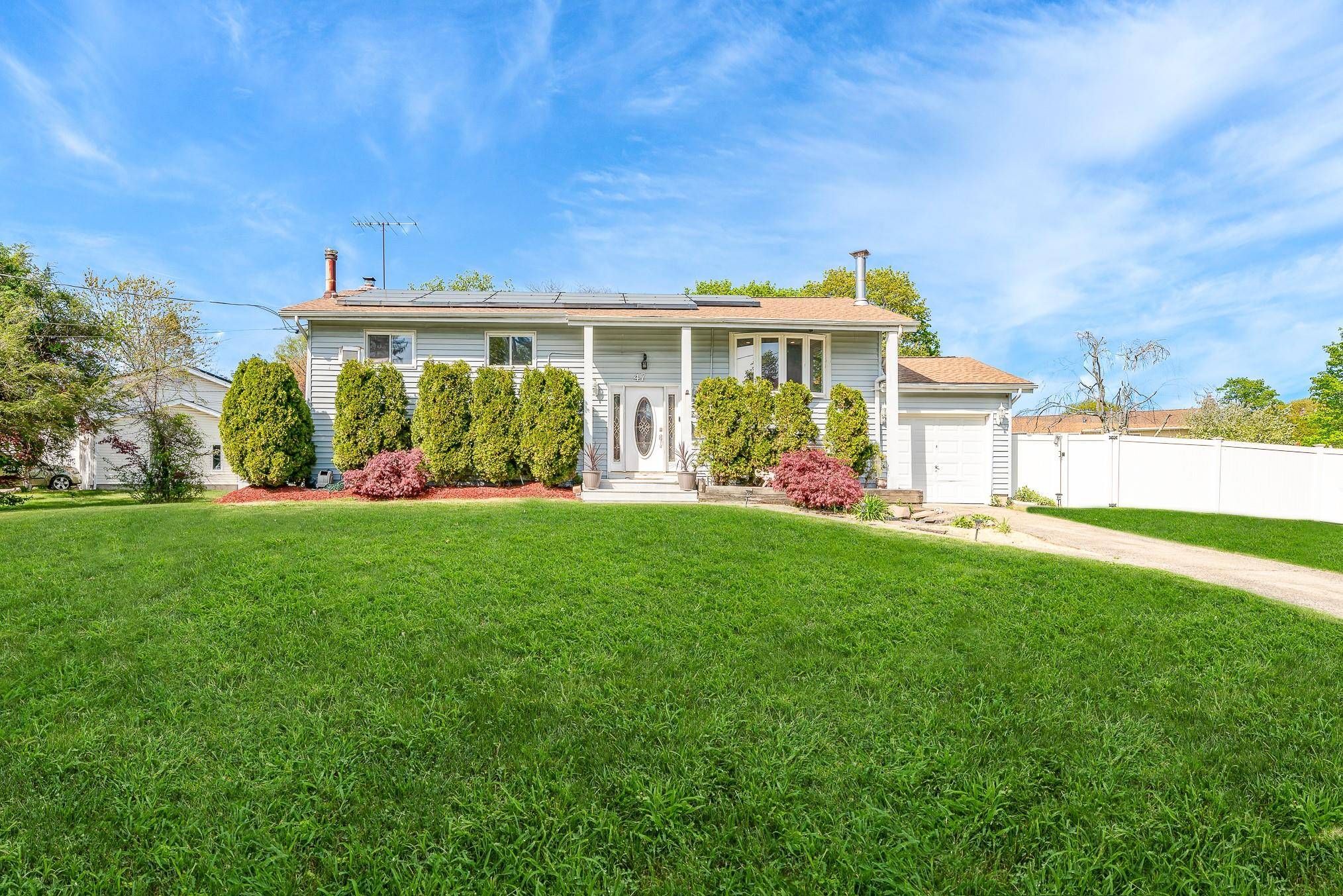 Welcome to this spacious Hi Ranch in the Wheatley Heights community within Half Hollow Hills School District.