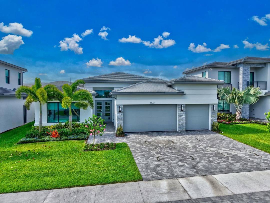 Live like you're on vacation every day in this rare Santo Grand with serene lake views and a private pool, located in Boca Raton's premier community, Lotus Palm.