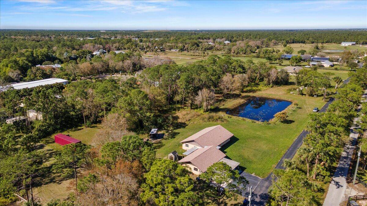 This is the BEST PRICED home on almost 5 acres in all of Palm City Farms !