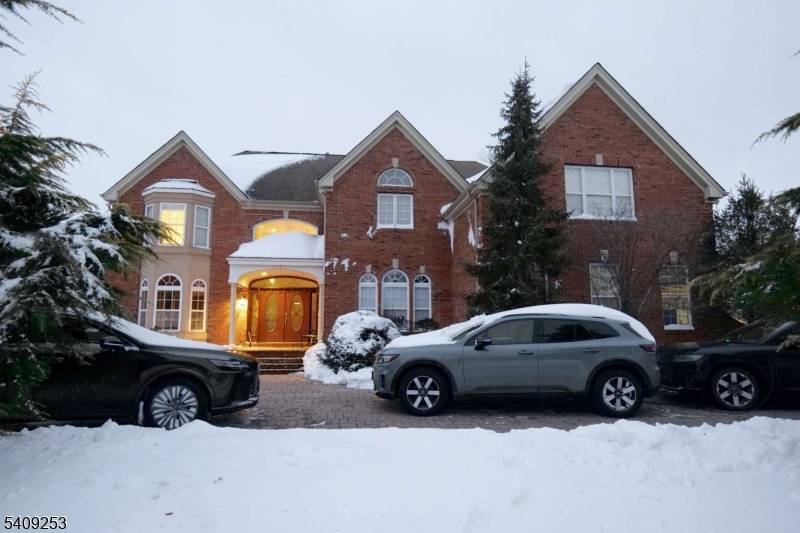 A grand three story residence offering timeless design with modern refinement across approximately 4800 square feet, including a fully finished basement level.