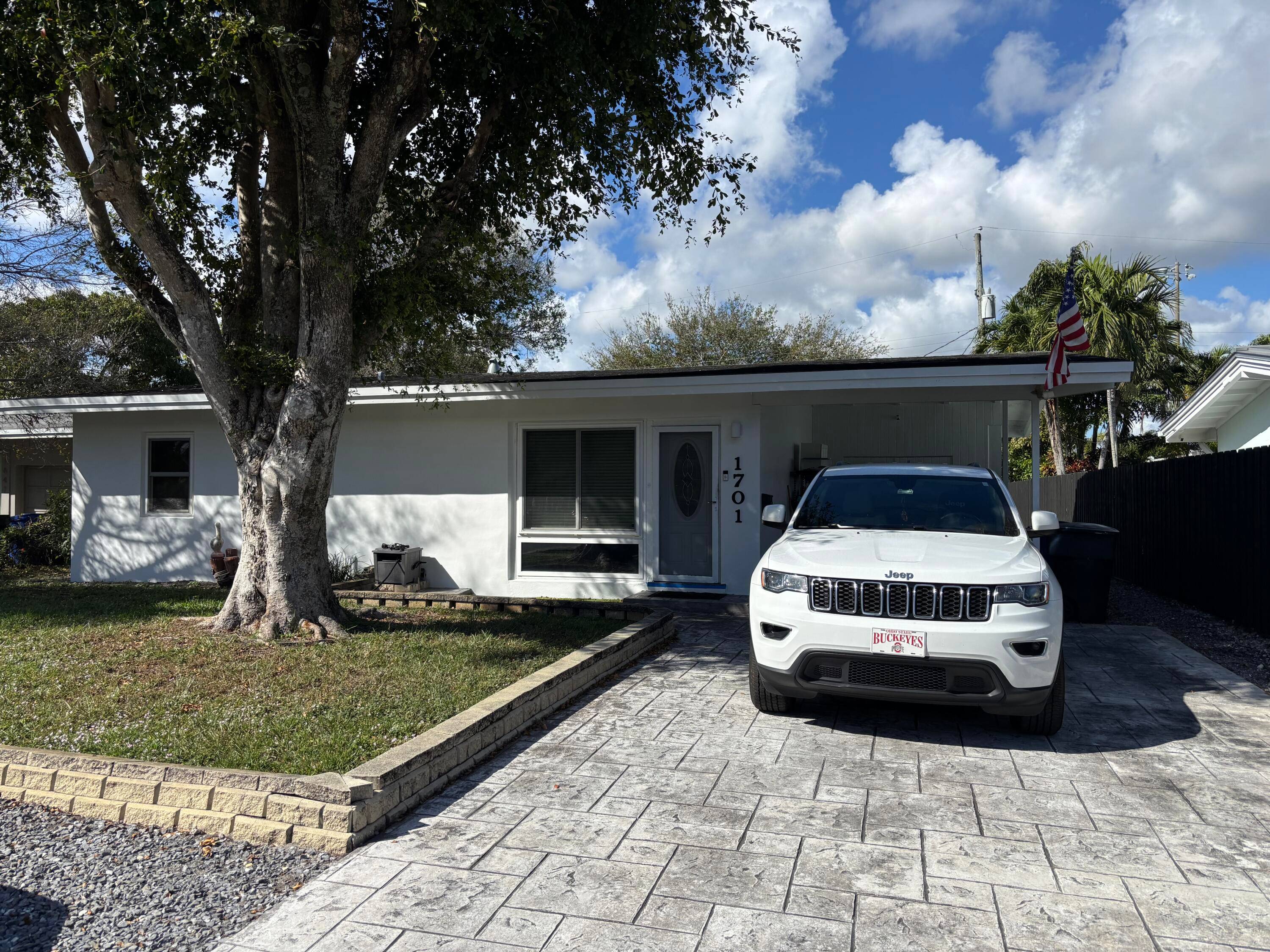 Just minutes from Wilton Drive yet tucked into a peaceful neighborhood, 3 2 home's curb appeal shines with a freshly painted exterior, decorative stamped concrete driveway, and a shady carport ...