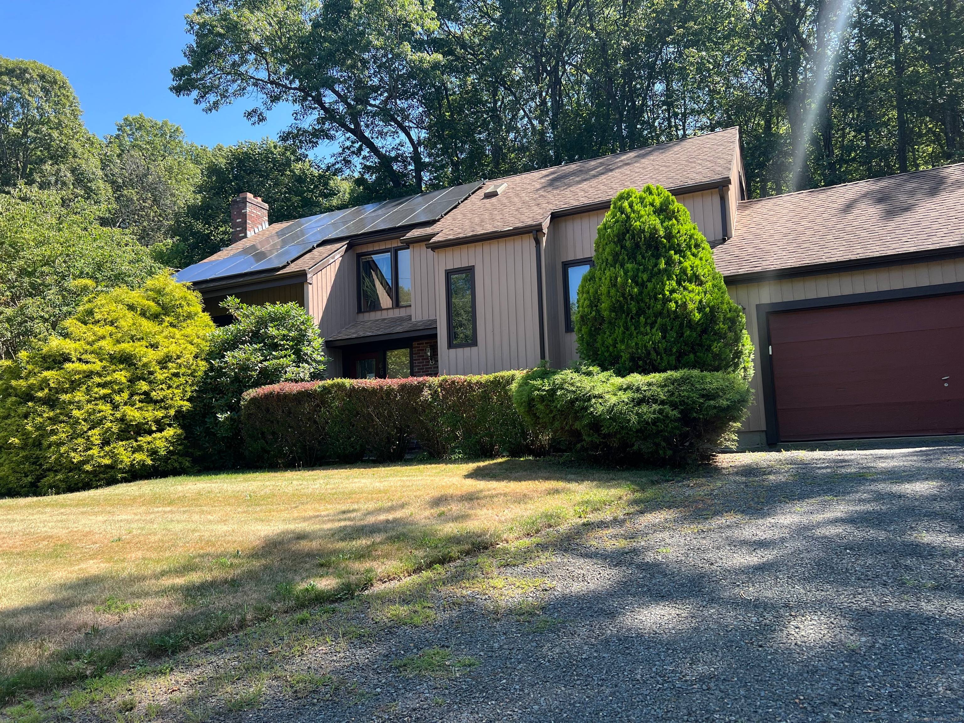 Step into your secluded nature haven, where modern architecture blends with the timeless appeal of Hamden's desirable Mount Carmel neighborhood.