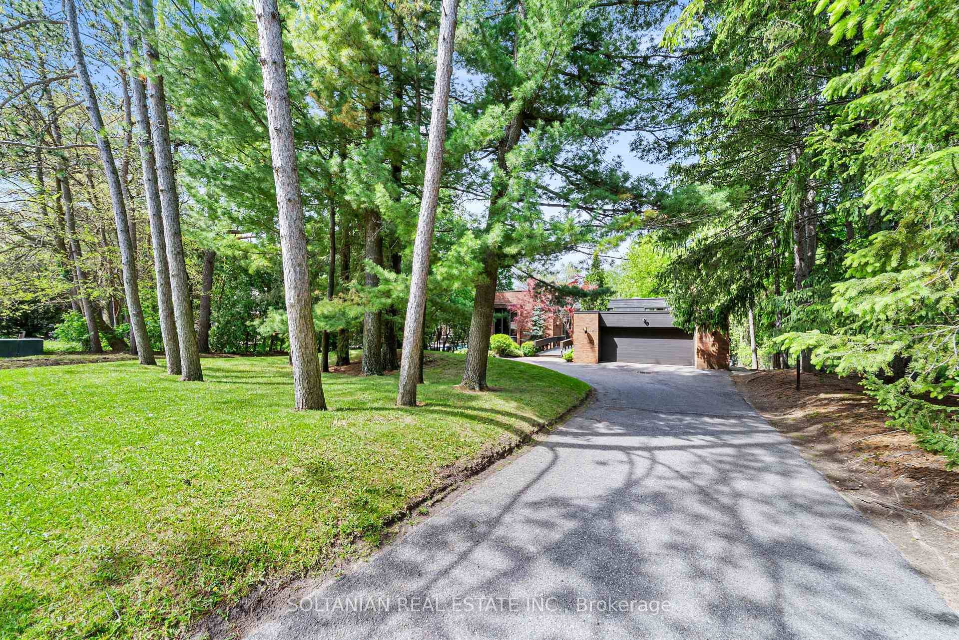 Welcome to 18 Old English Lane, a remarkable estate designed with vision and craftsmanship, set on a breathtaking 1 acre ravine lot in the prestigious Bayview Glen community.