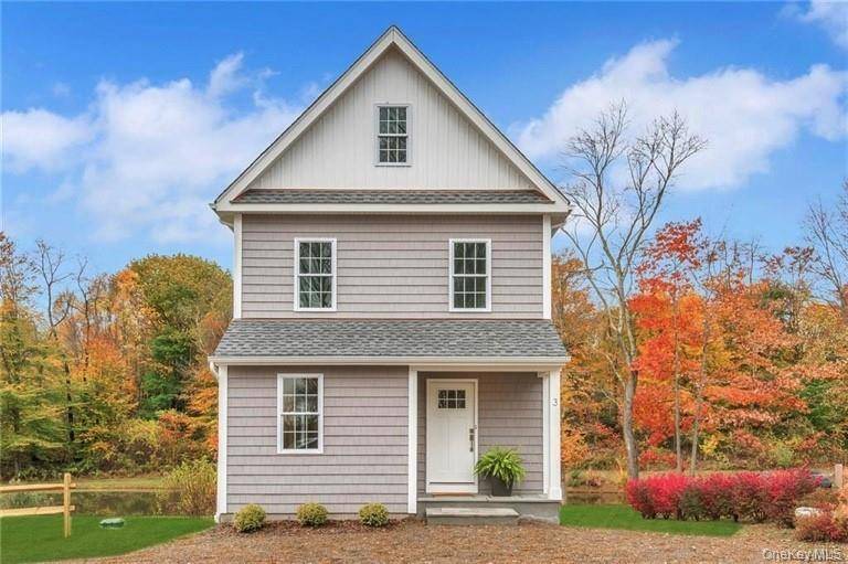 Modern country home with pond and long driveway that adds to its charm and privacy.
