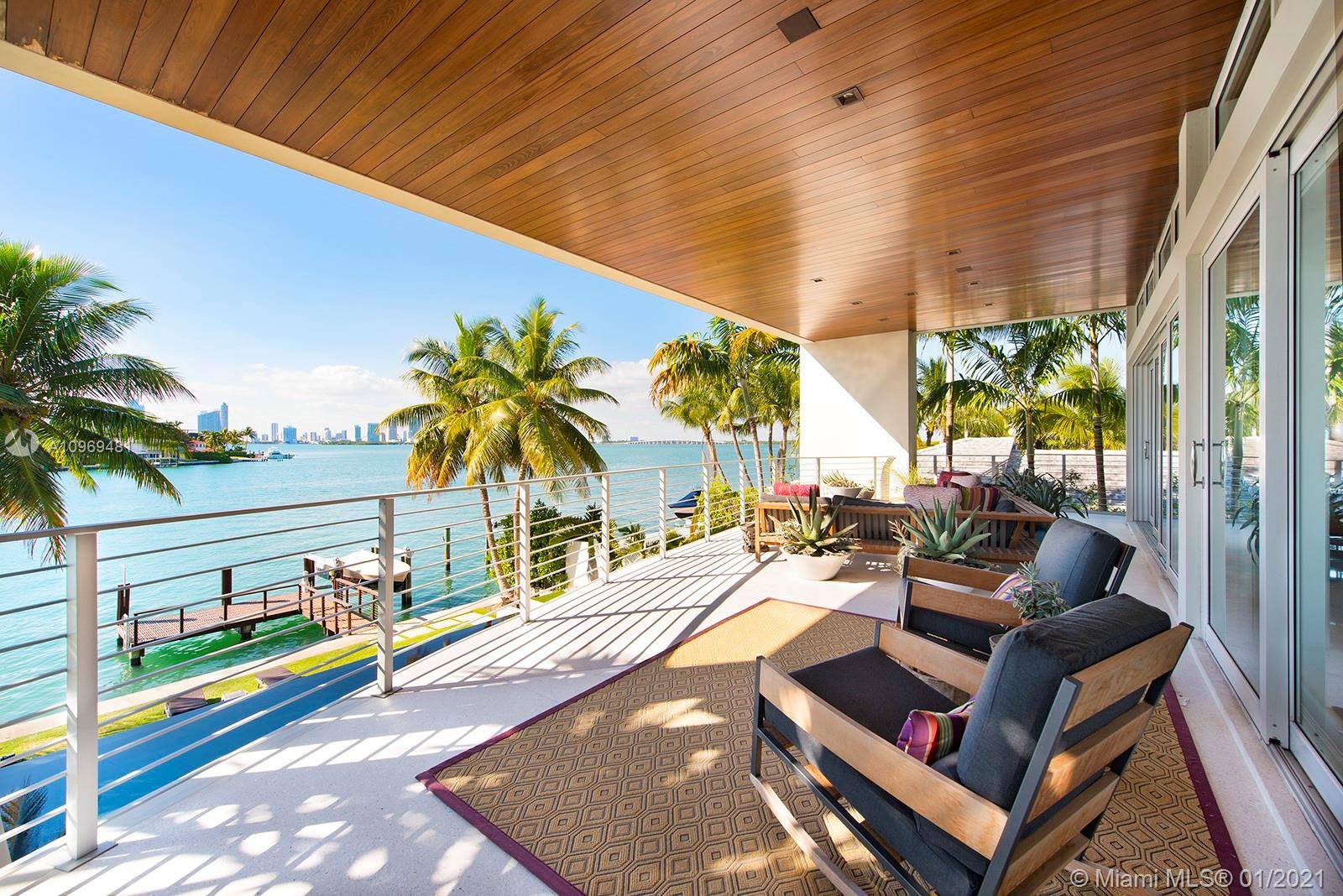 Stunning tropical modern home with wide open west bay views.