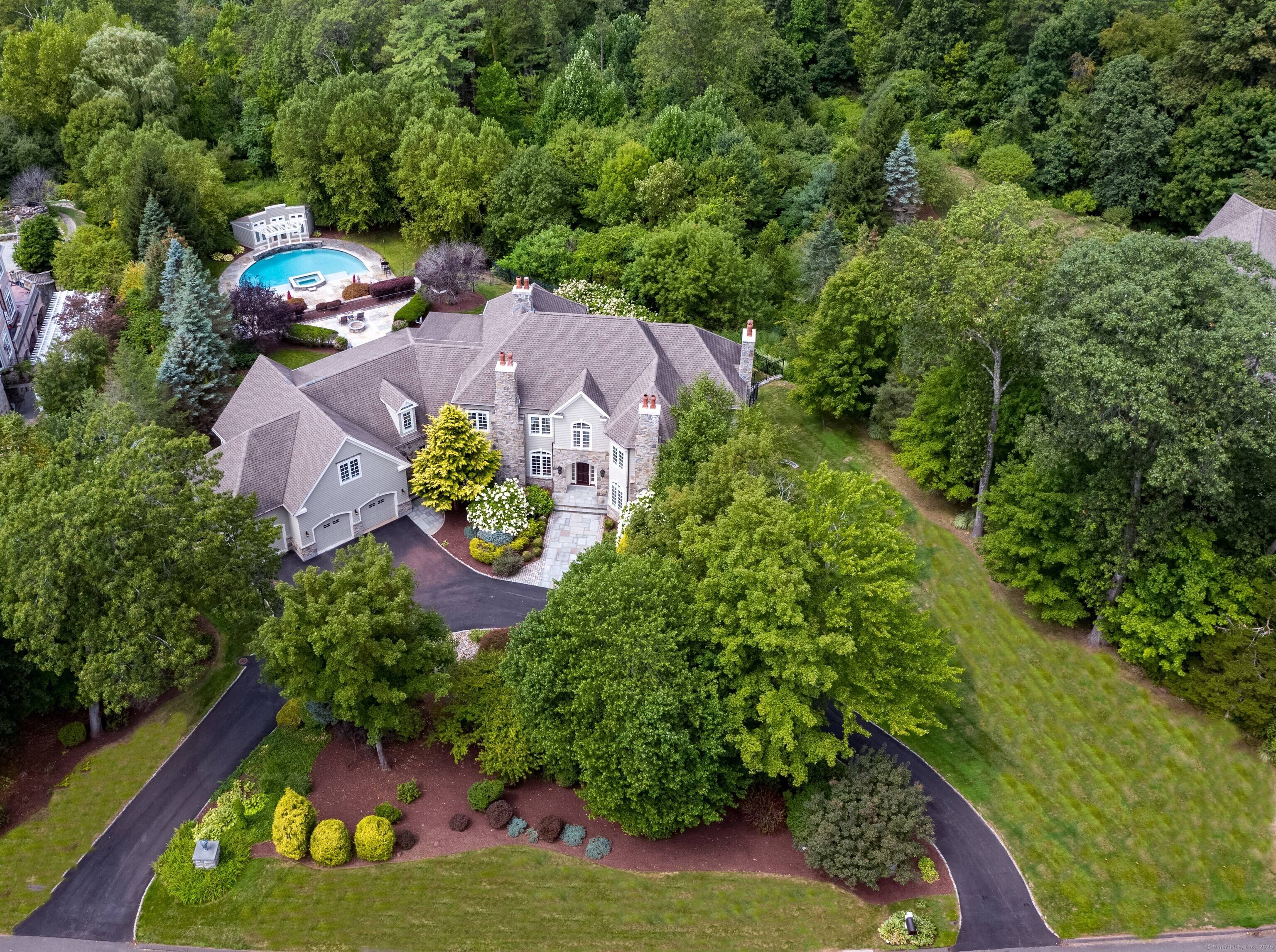 Breathtaking westerly views from this remarkable Stone Shingle style home privately set in a coveted east side enclave of distinguished homes.