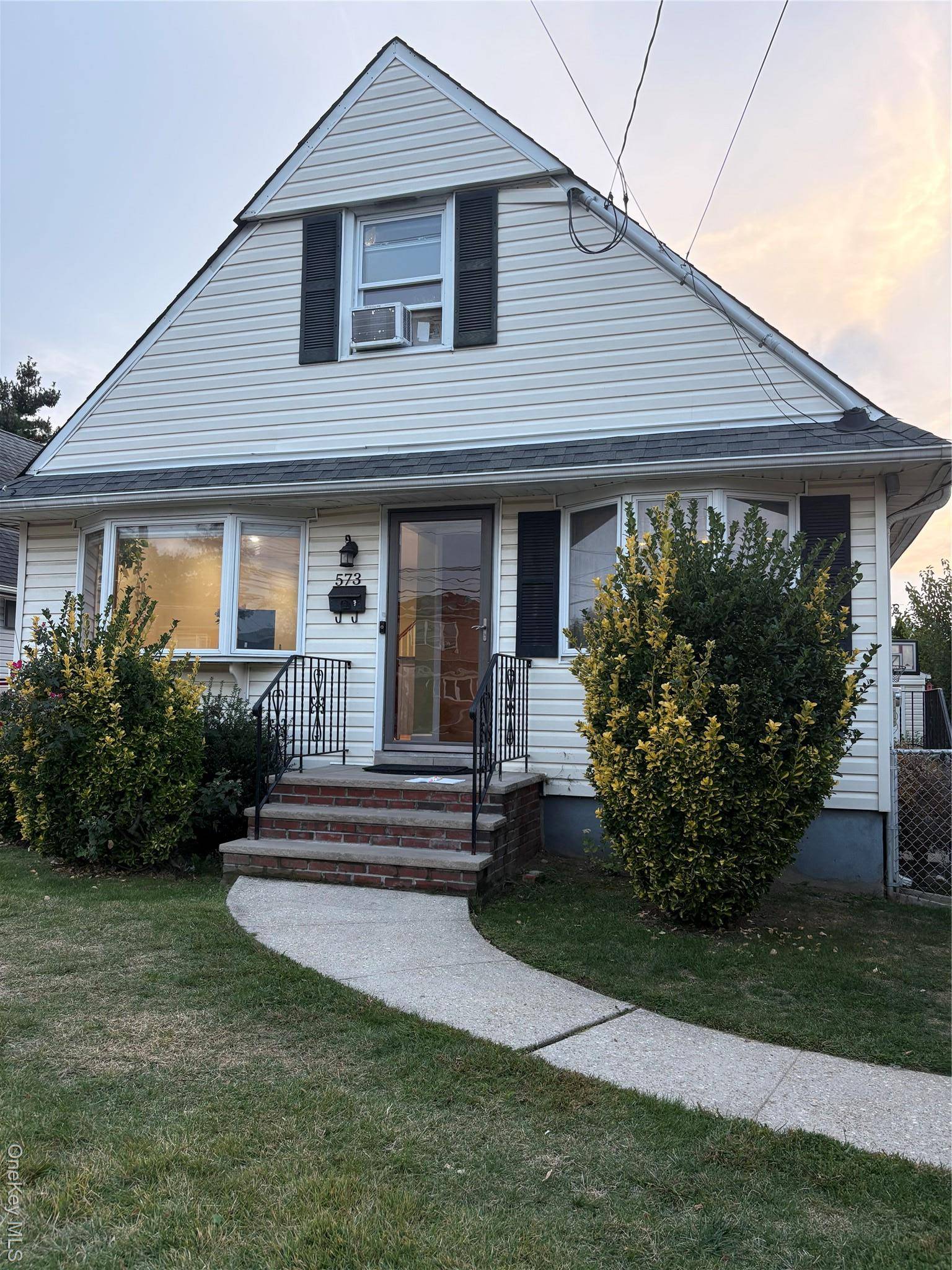 Charming 4 Bedroom Cape on Lakeville Road featuring gleaming hardwood floors.