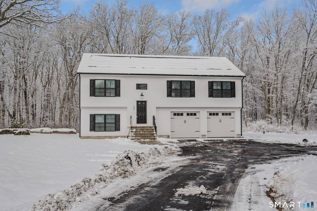Built in 2022, this beautifully maintained raised ranch sits on a private 5.