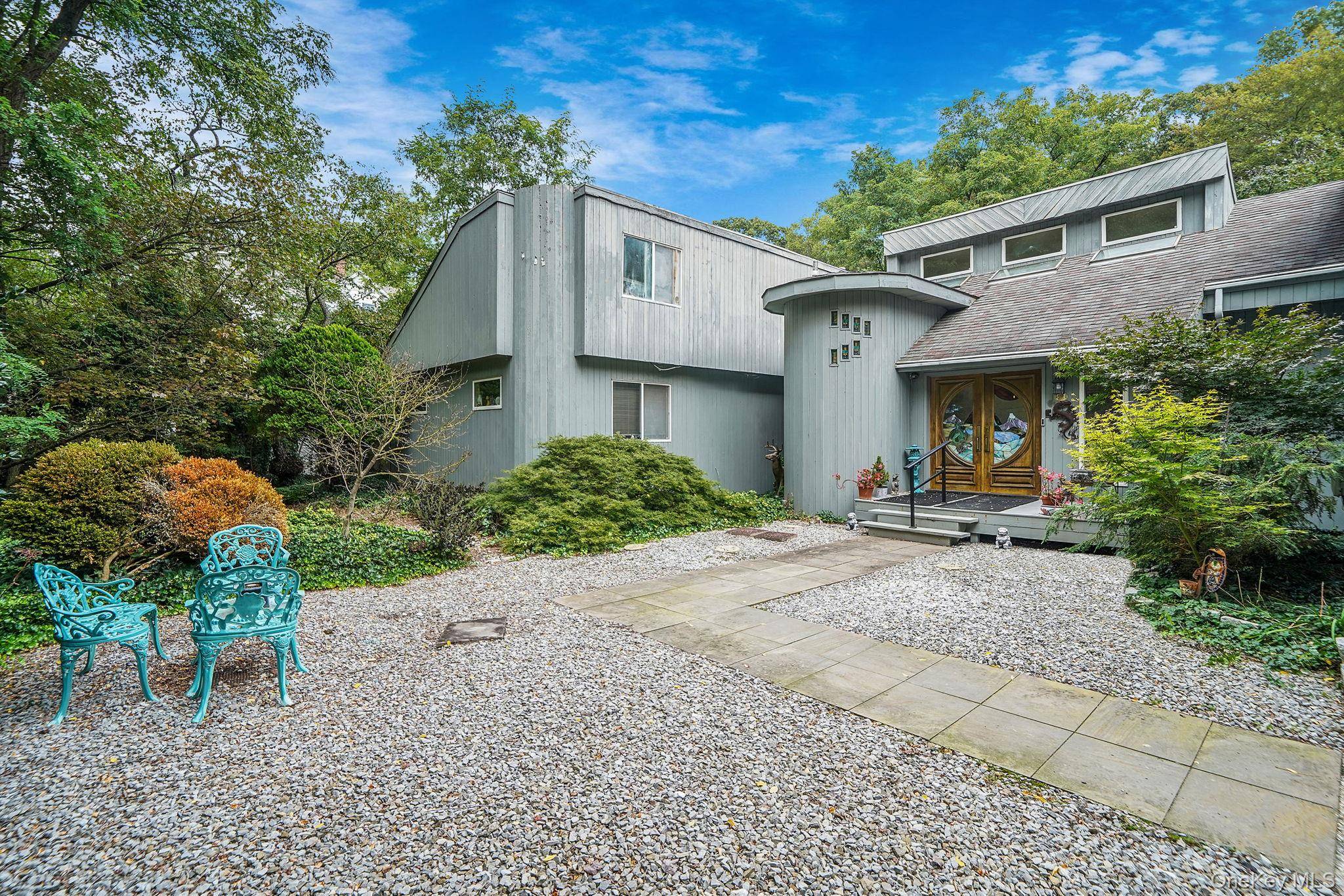 Welcome to this exceptional Fort Salonga residence offering over 4, 000 sq ft of living space on a private, wooded acre.