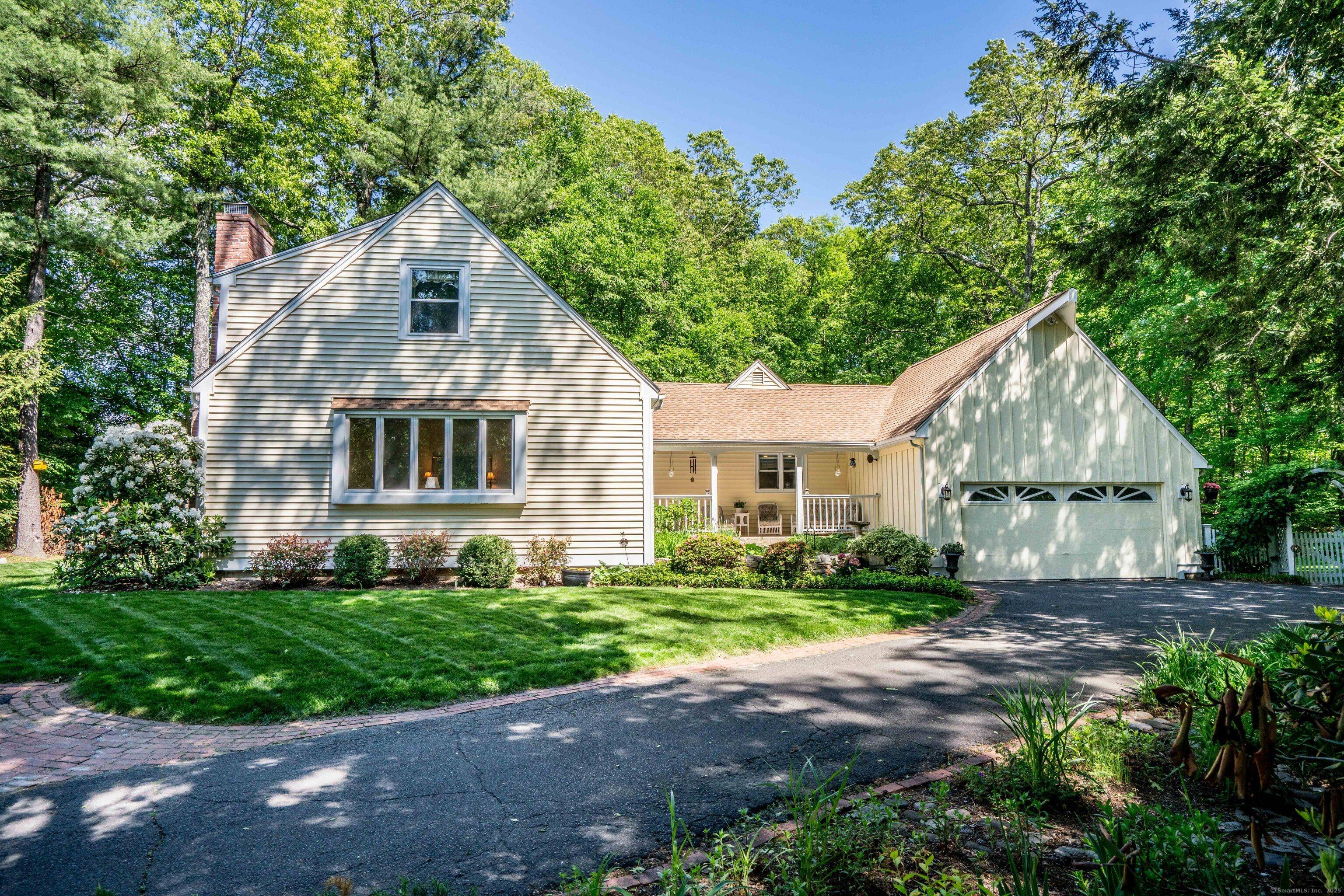 MOVE IN READY. A private, winding drive leads to this charming, well cared for cape surrounded by lush yard and flowering gardens.