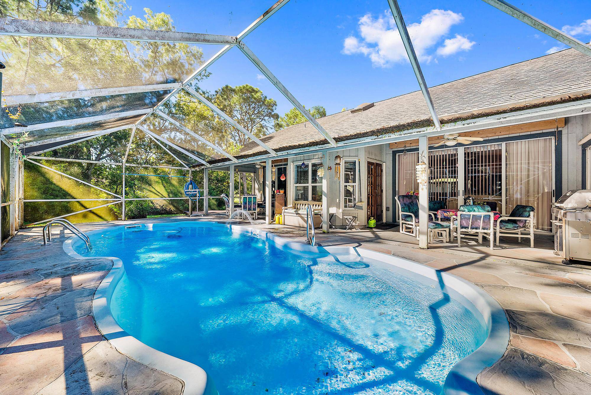 Nestled in the heart of Jupiter Farms, this charming home, situated on 1.