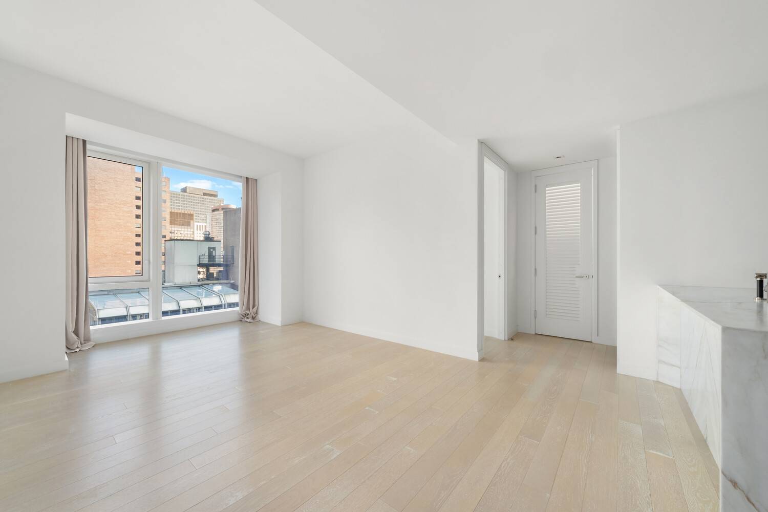This elegant one bedroom, one bathroom residence, designed by Champalimaud, showcases sweeping northeast views of the Manhattan skyline through expansive floor to ceiling windows.
