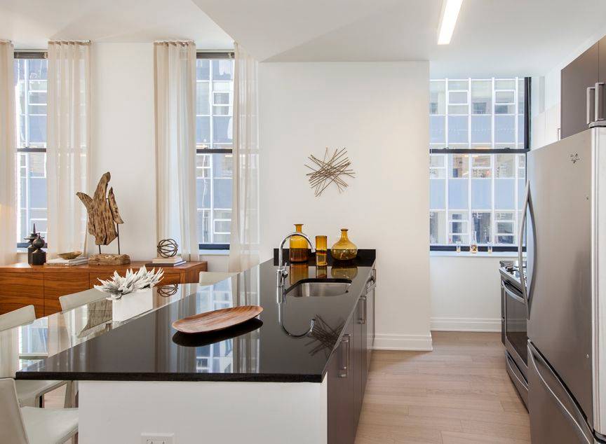 Corner 2 bed with private terrace, split beds, windowed gourmet kitchen, high ceilings, wood floors, and in unit washer dryer.