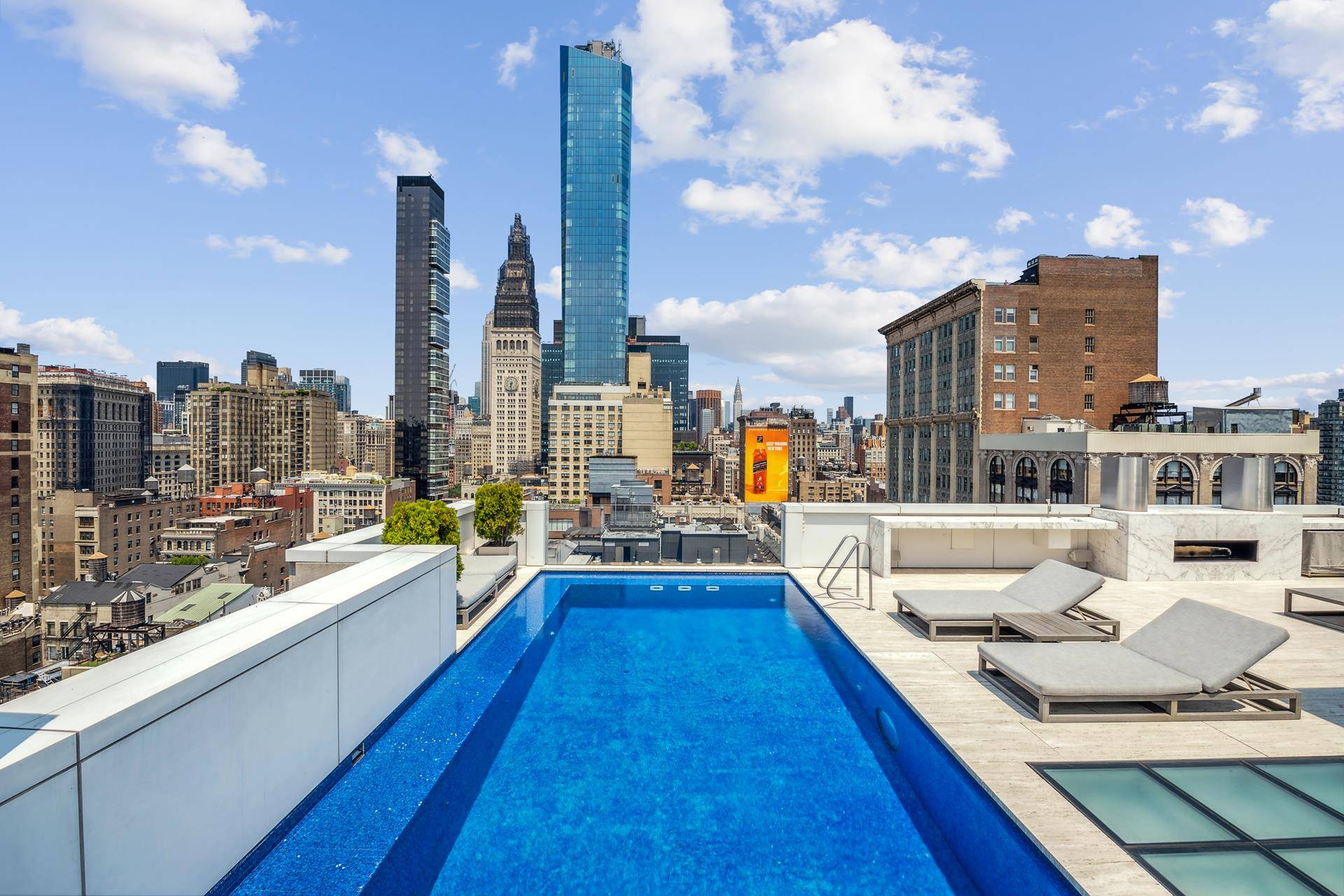 The triplex penthouse offers the most stunning private pool in all of Manhattan a thirty feet long masterpiece constructed of custom blue Mosaic Bisazza and infinity glass wall.