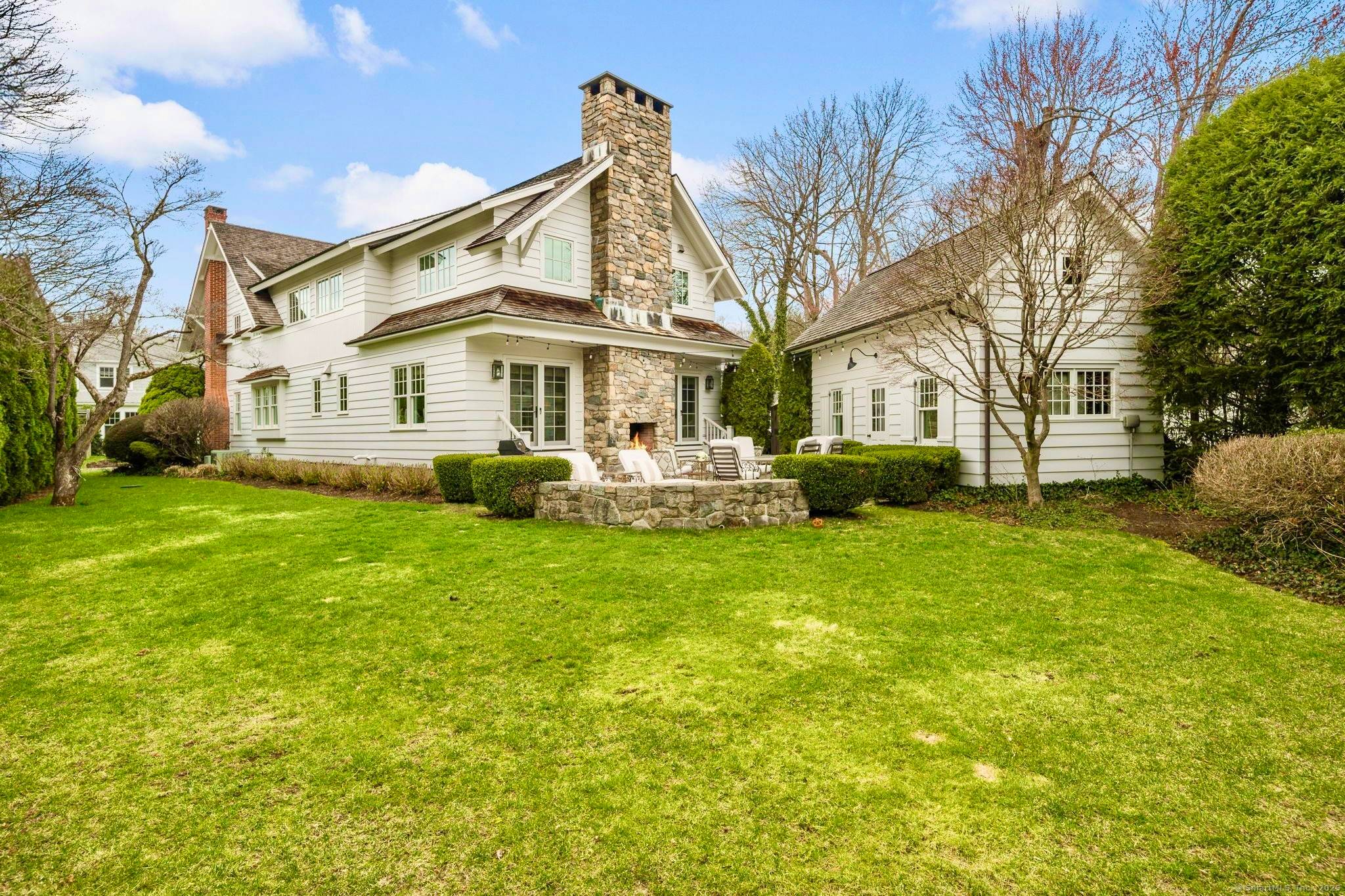 Nestled in Rowayton, this meticulously renovated Coastal Cottage boasts five bedrooms and four and a half bathrooms, including two primary bedrooms with en suite bathrooms.