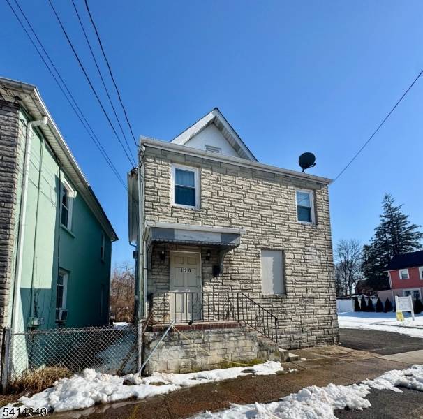 Commercial building located on a double lot in a Residential neighborhood, currently utilized as a House of Worship.
