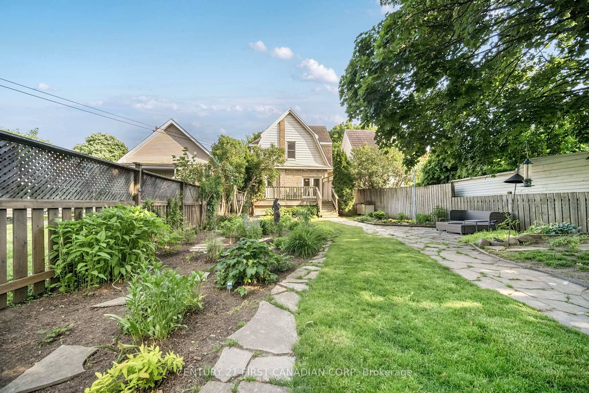This incredibly well kept yellow brick century home sits on a deep lot on a quiet, tree lined street.