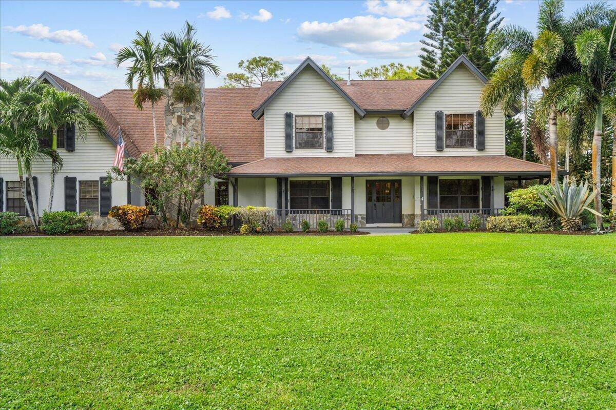 This Northern style colonial home is nestled on 5 acres of breathtaking land within the exclusive, gated Equestrian community of Homeland.