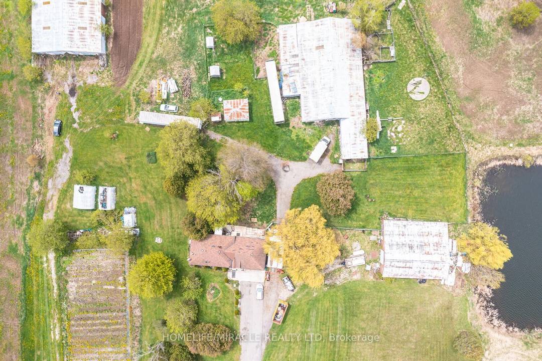 49. 22 Acres corner farm house with Charming 3 Bedroom, 2 Car Garage Bungalow, Multi use other Buildings including Two Barns, Storage space, Drive in Shop.