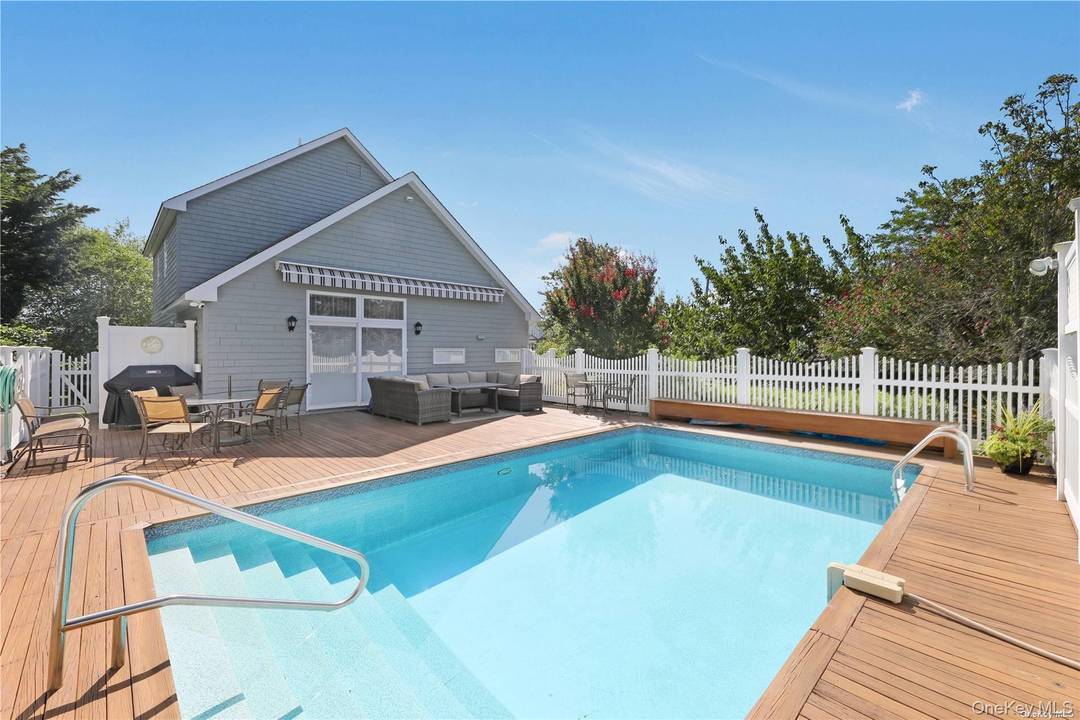 Experience the quintessential Hamptons lifestyle in this immaculate Remsenburg residence, ideally located south of South Country Road on a quiet waterfront street just moments from Moriches Bay.