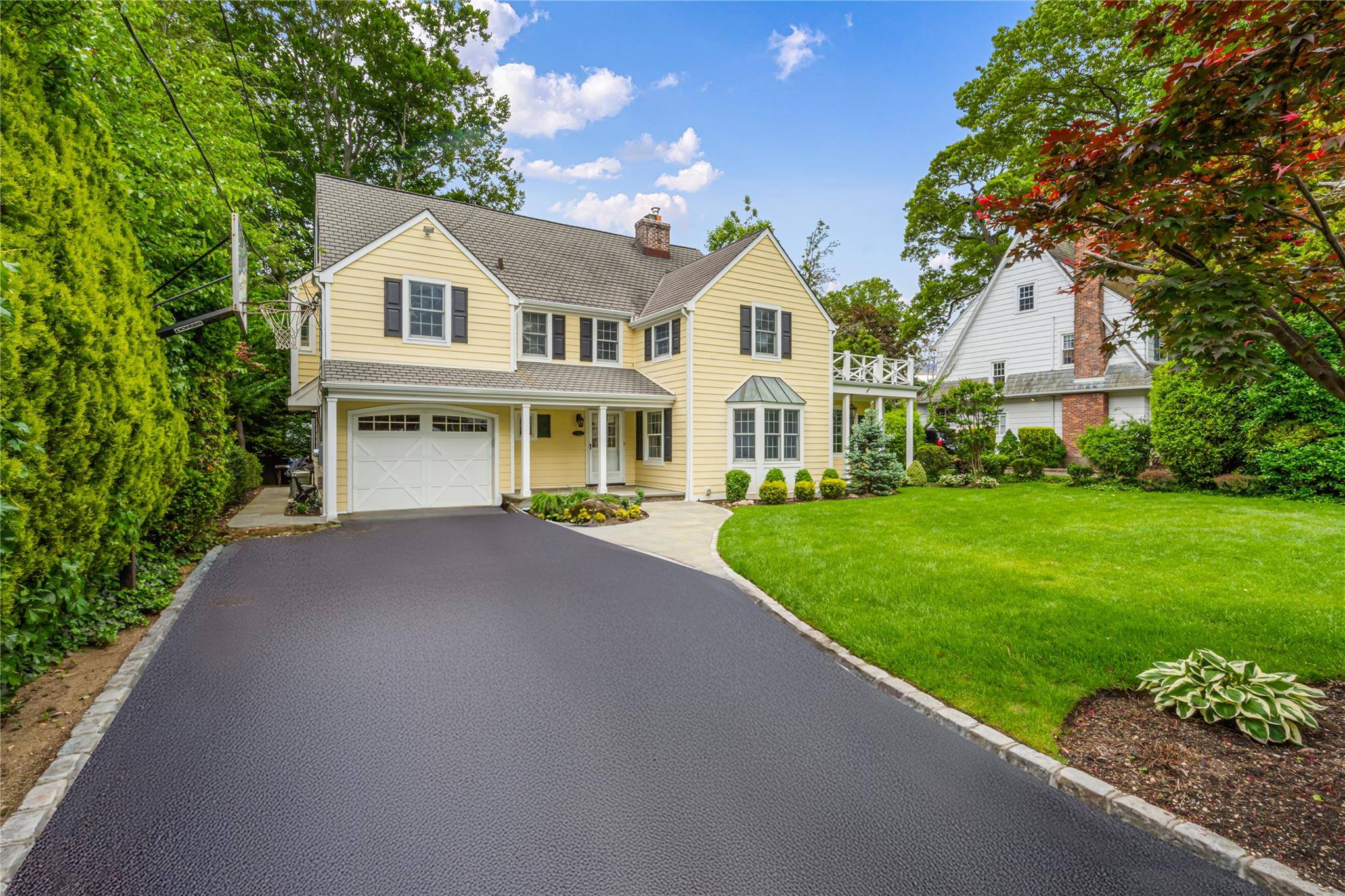 Discover timeless elegance in the heart of Munsey Park at 74 Eakins Road, Manhasset.
