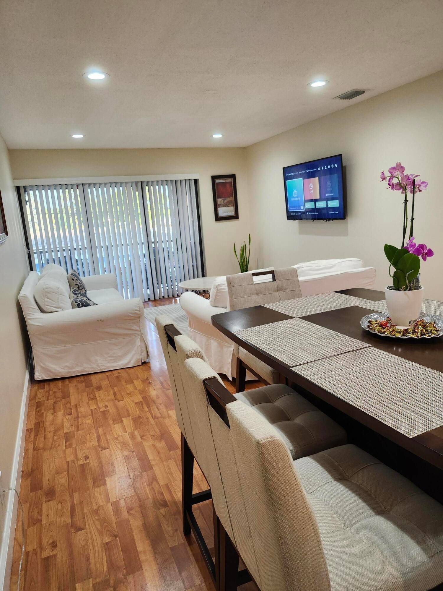 Open concept living area condo with spacious kitchen, stone countertops and stainless steel appliances.