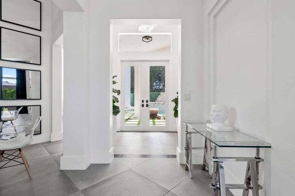 This is a contemporary home on a large, beautiful corner lot in a security gated community.