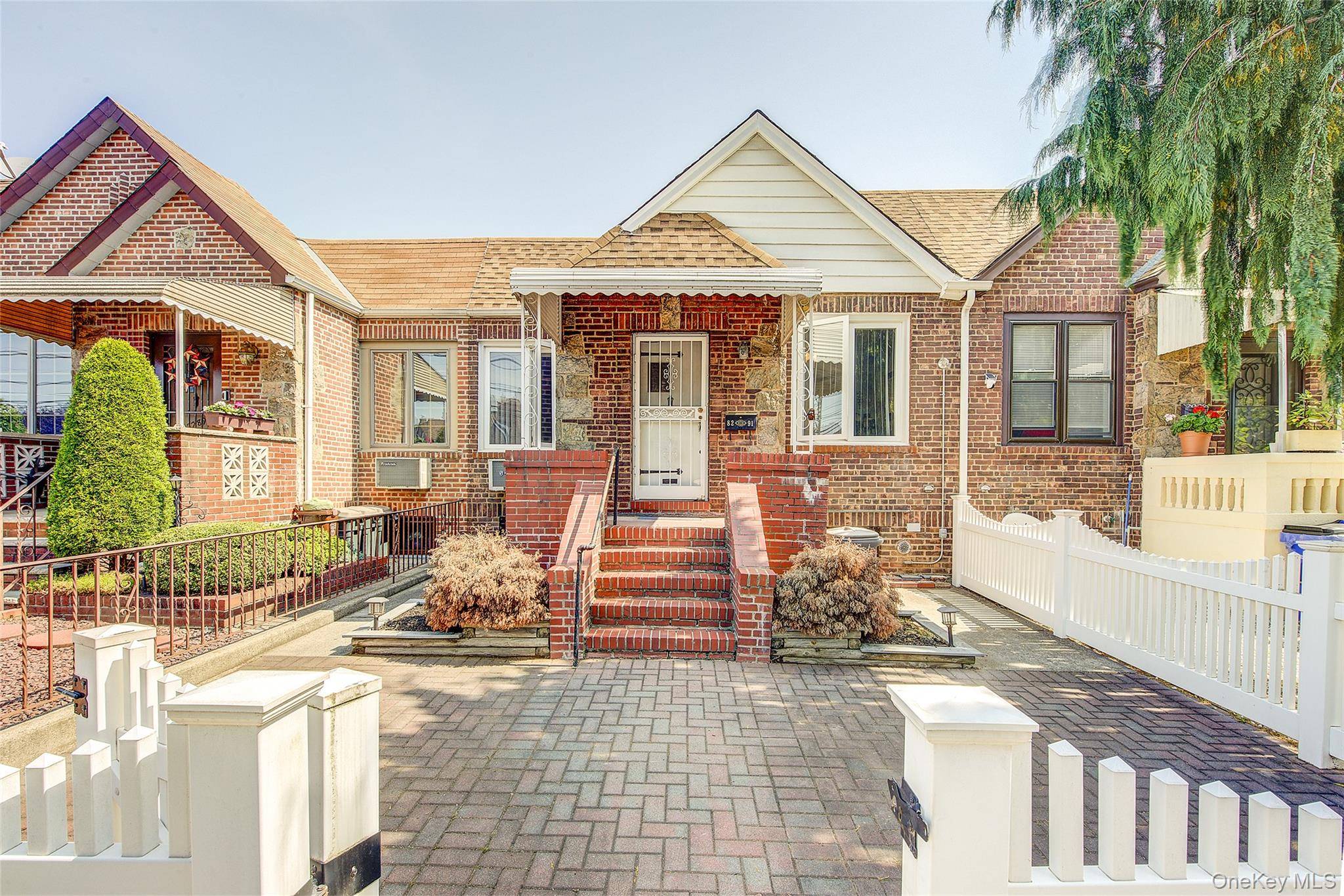 Charming single family attached home on a beautiful rowhouse block in Middle Village North.