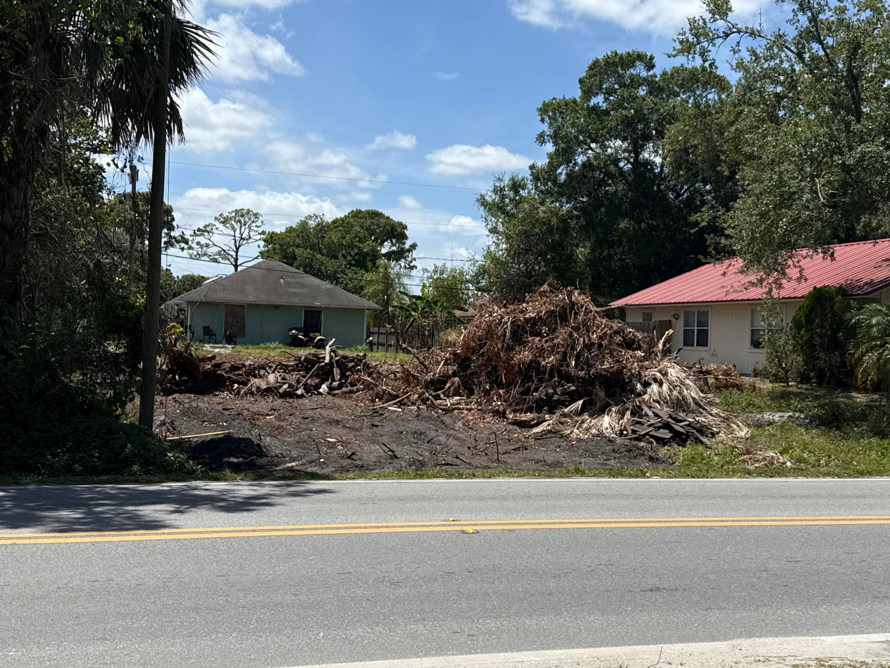 Buildable lot on paved road in Oslo Park being cleared.