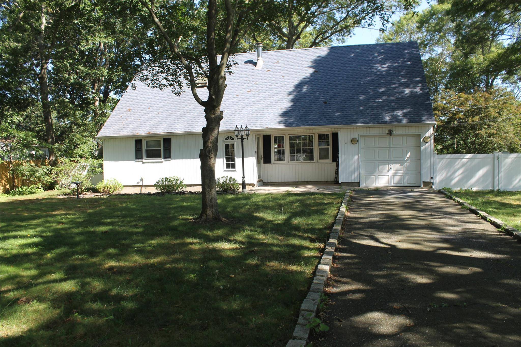 Welcome home to this spacious expanded cape in the heart of Shirley.