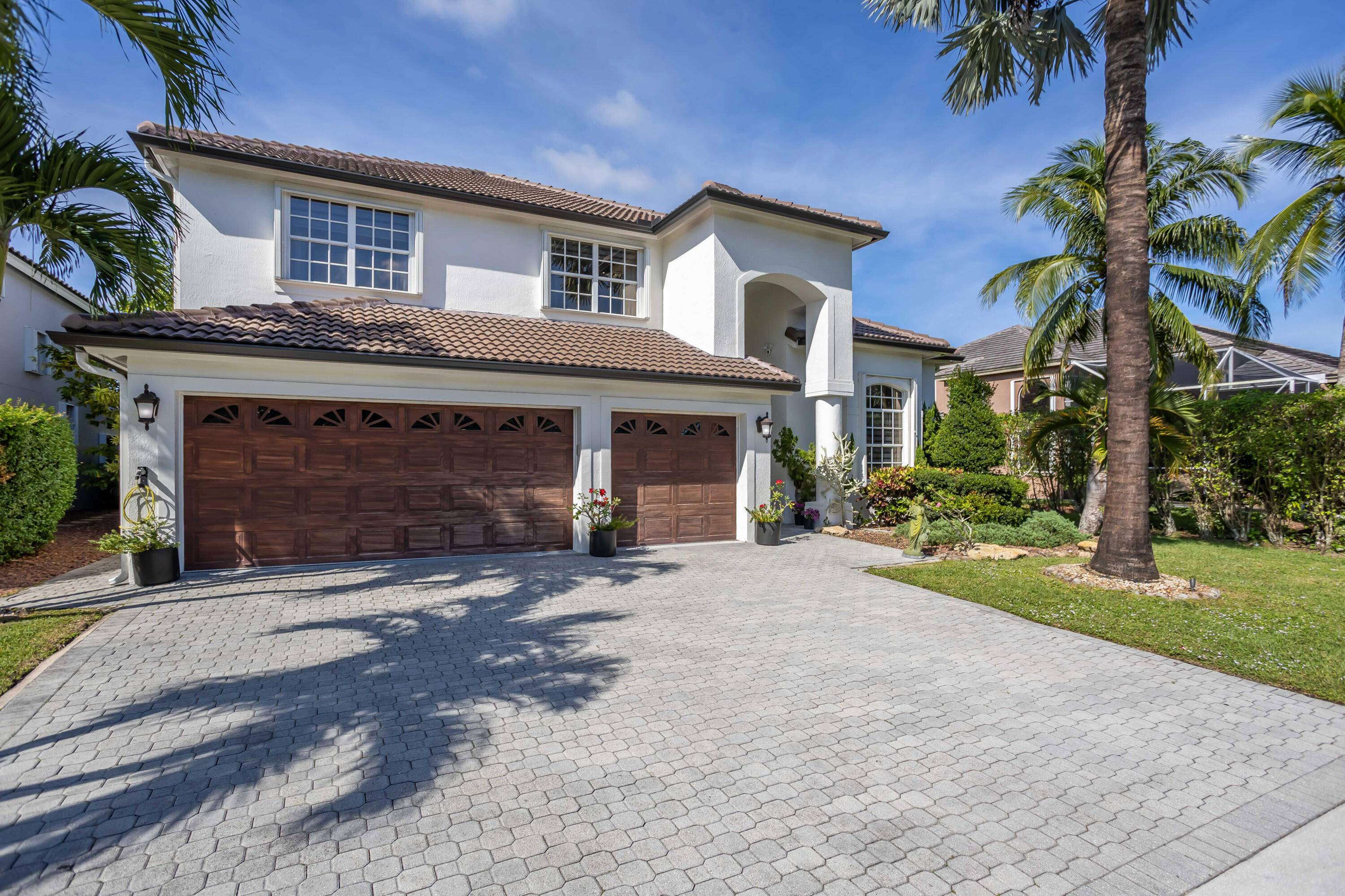 Step into timeless sophistication and modern elegance in this impeccably updated lakefront estate in the prestigious gated community of Boca Falls.