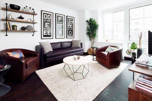 Spacious studio featuring an in unit washer dryer, over sized windows showcasing open views across 12th Street, and a fully equipped gourmet kitchen with a paneled dishwasher, Liebherr refrigerator, custom ...