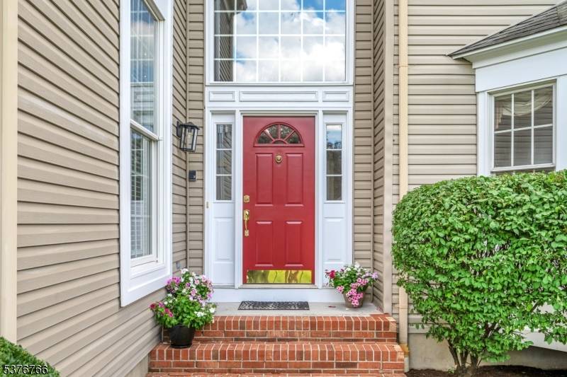 A grand two story foyer with winding stairway and hardwood floors greets you as you enter this gracious home in the Prince Edward Pointe section of Basking Ridge !