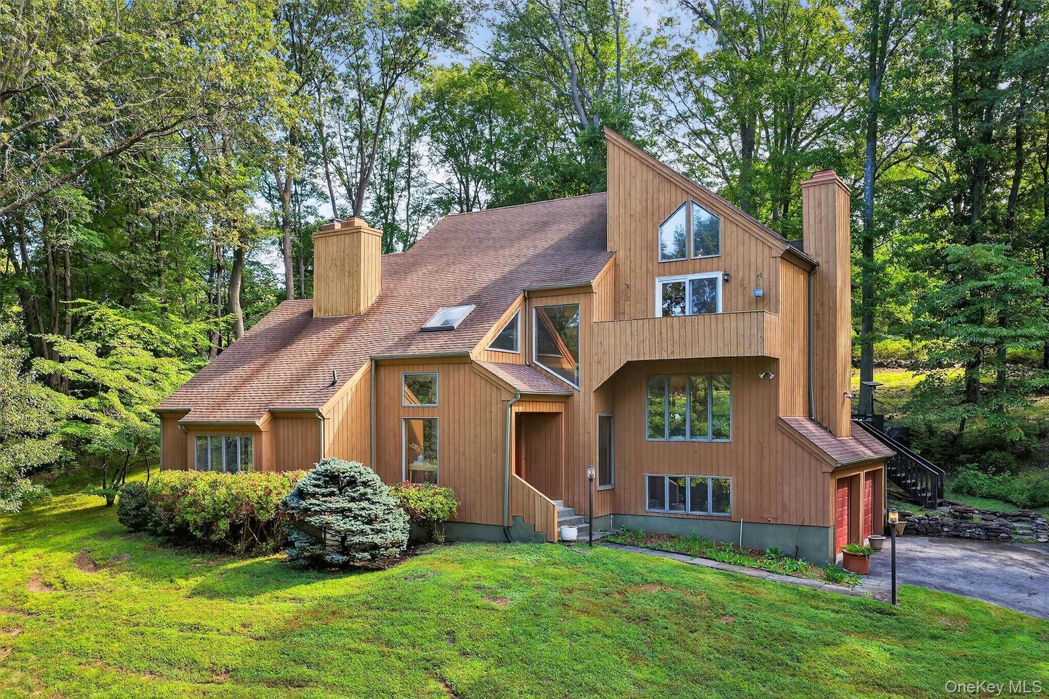 Nestled on nearly two acres of lush, tree lined property, this sun filled contemporary home radiates comfort, character, and connection to nature.