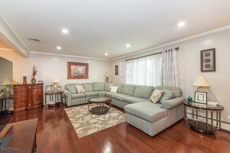 Beautiful bi level with remodeled kitchen featuring granite counters, glass backsplash and stainless steel appliances.